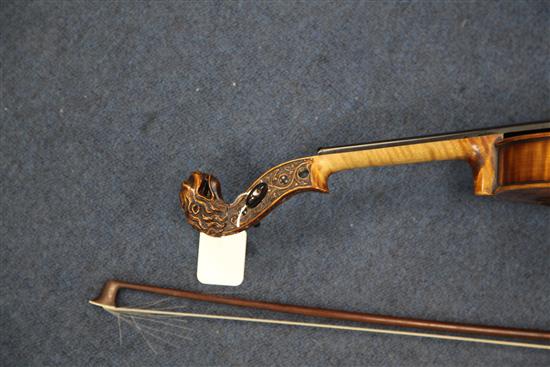 A decorative violin, bearing Gaspar da Salo label, body 14.5in., overall 23.5in., cased with a bow